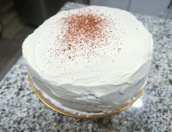 an image of a torte frosted with whipped cream and finished with chocolate shavings